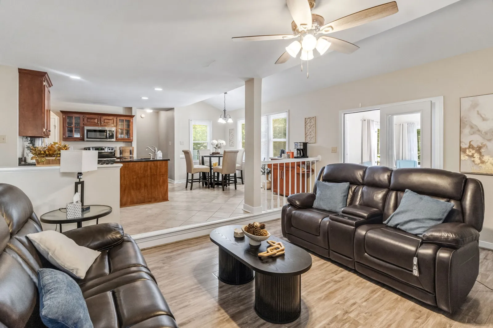Family room with vaulted ceiling open to the kitchen and doors to the sunroom