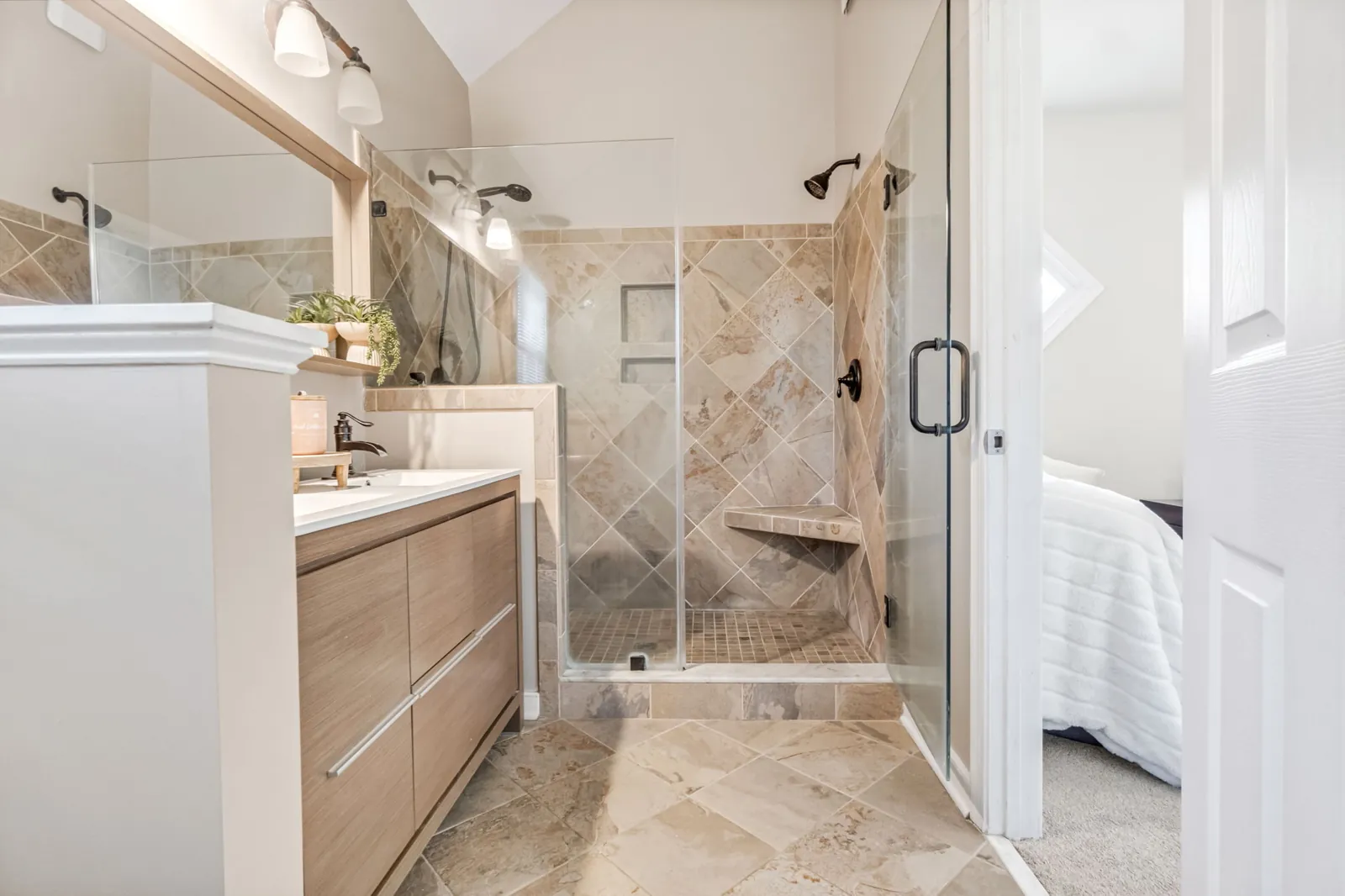 Primary bathroom with tiled walk-in shower and dual shower heads