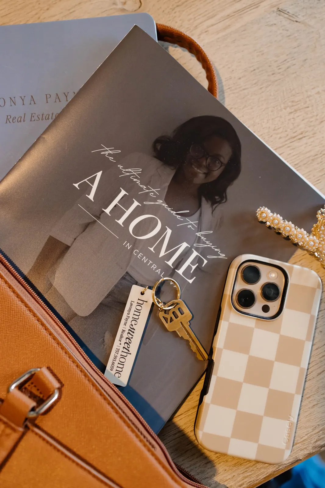 The Ultimate Guide to Buying a Home in Central VA with keys and a phone