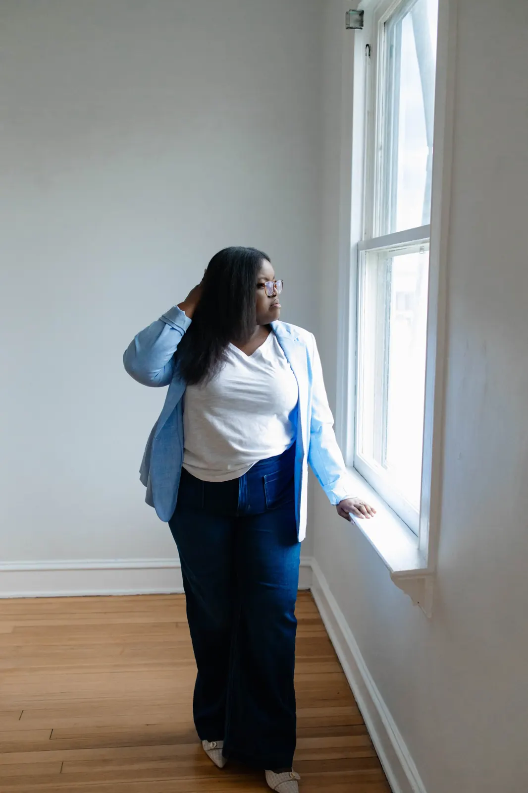 Lavonya Payne looking out the window of an empty room during a home showing in Central Virginia