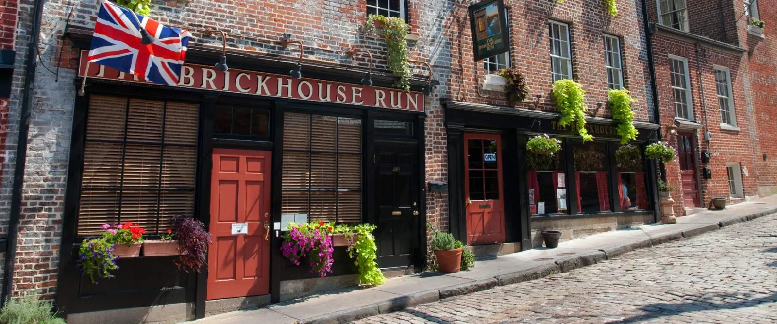 Brick storefronts and cobblestone street in Old Towne Petersburg, VA